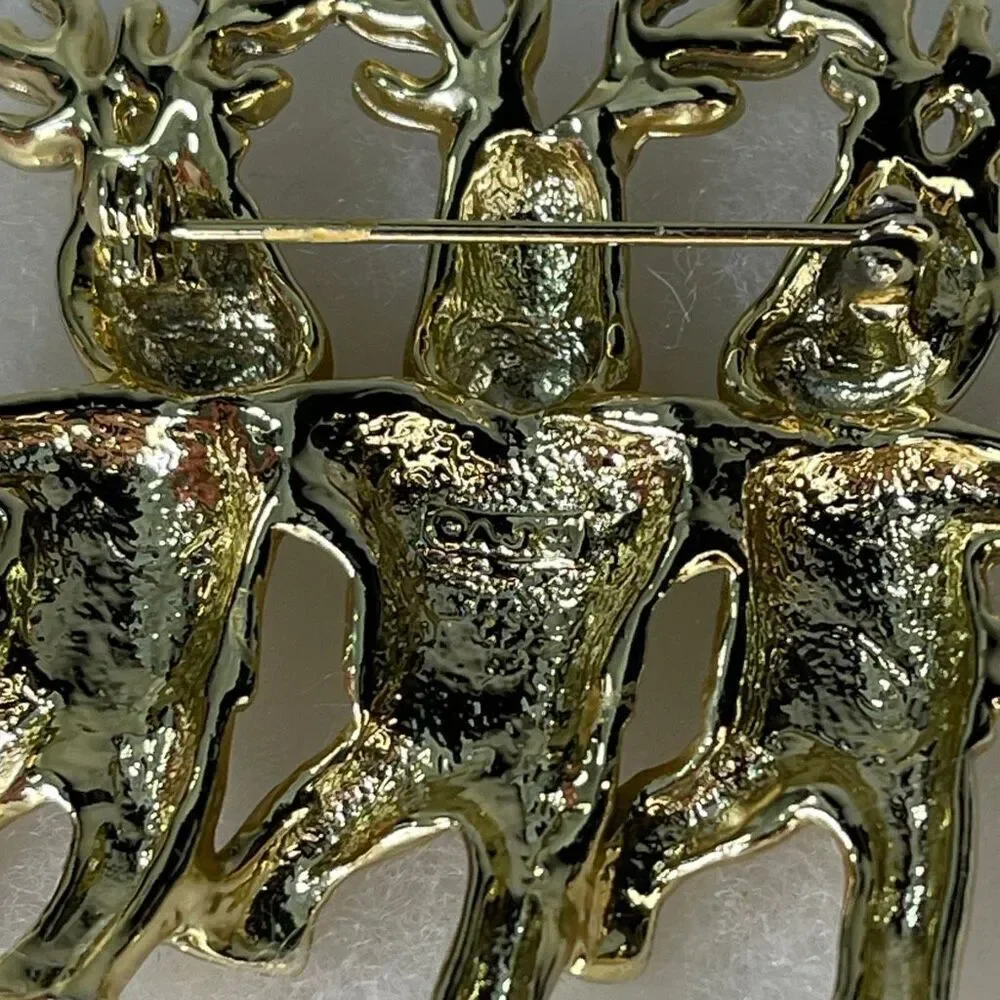 Vintage AJC three dancing deer gold tone brooch.